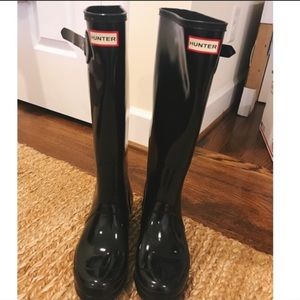 Tall glossy black hunter rain boots